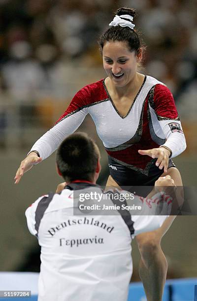 Anna Dogonadze of Germany runs into the arms of her coach after her routine in the women's trampoline final on August 20, 2004 during the Athens 2004...
