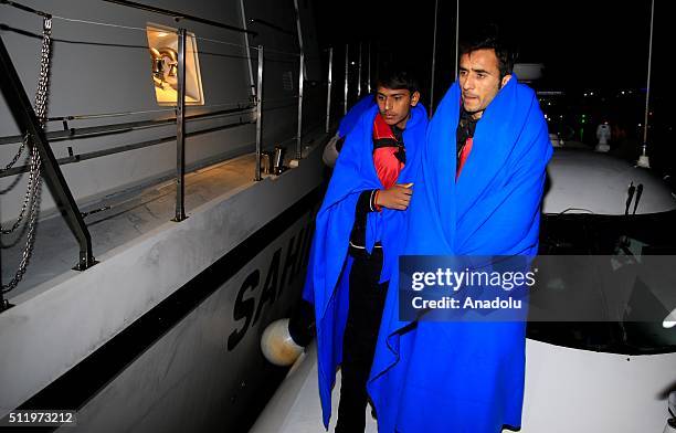Refugees disembark after they left a Turkish Coast Guard ship following a rescue operation for the asylum seeking refugees who were illegally trying...
