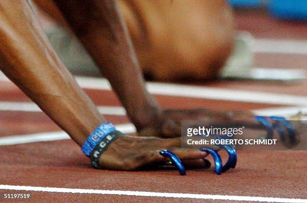 Close-up shows the blue fingernails of US athlete Gail Devers as she readies for the start of the women's 100m, heat one, round two, 20 August 2004,...