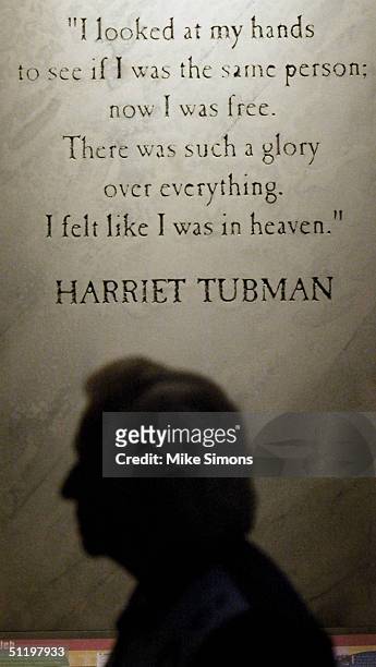 Visitor to the National Underground Railroad Freedom Center is silhouetted against a Harriet Tubman quote August 20, 2004 in Cincinnati, Ohio. The...