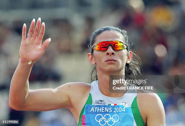 World 400m champion Ana Guevara of Mexico waves after she won heat one, round one of the women's 400m race, 21 August 2004, during the Olympic Games...
