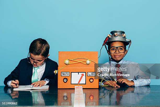 two young businessman with lie detector - liar stock pictures, royalty-free photos & images