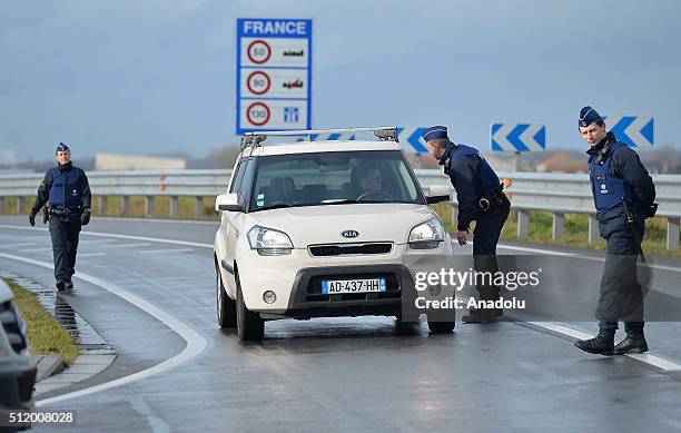 Belgian police check the vehicles to prevent refugee entrance into the country as vehicles cross the border from France into Belgium, in De Panne...