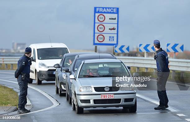 Belgian police check the vehicles to prevent refugee entrance into the country as vehicles cross the border from France into Belgium, in De Panne...