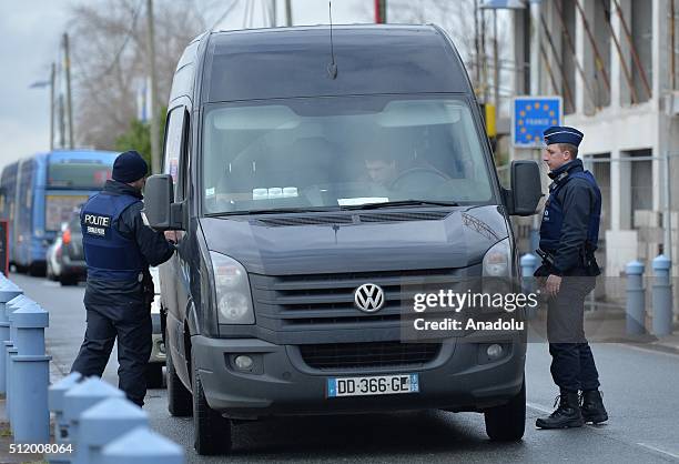 Belgian police check the vehicles to prevent refugee entrance into the country as vehicles cross the border from France into Belgium, in De Panne...