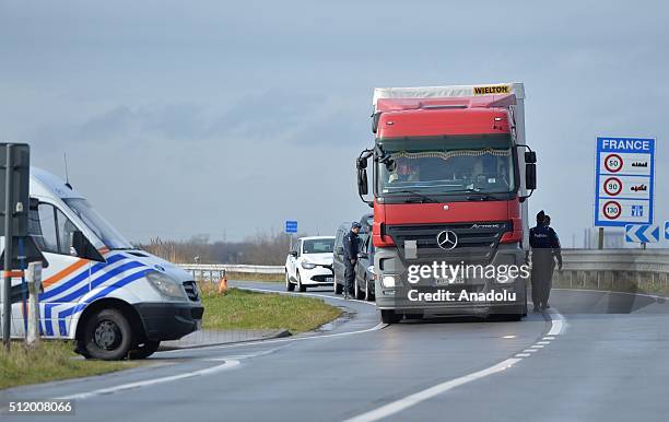 Belgian police check the vehicles to prevent refugee entrance into the country as vehicles cross the border from France into Belgium, in De Panne...