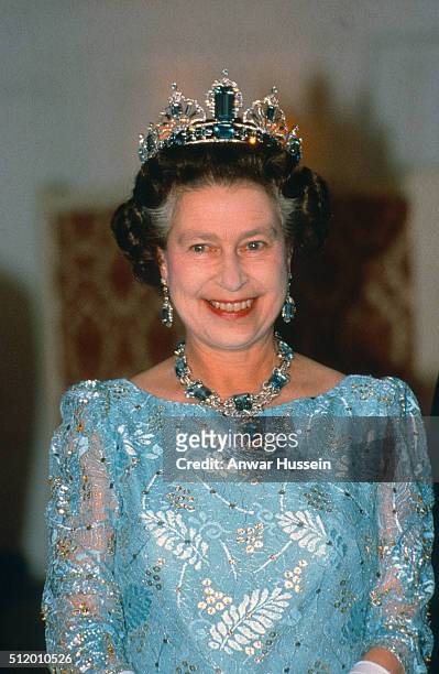 Queen Elizabeth ll, wearing the Brazilian Aquamarine Prure Tiara and necklace, smiles as she attends a banquet in Canton during her visit to China on...