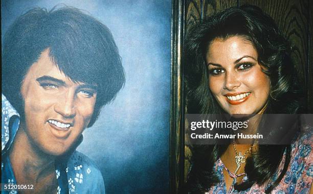 Ginger Alden, fiancee of Elvis Presley and the last person to see him alive, stands beside a portrait of Elvis on April 01, 1978 in USA.