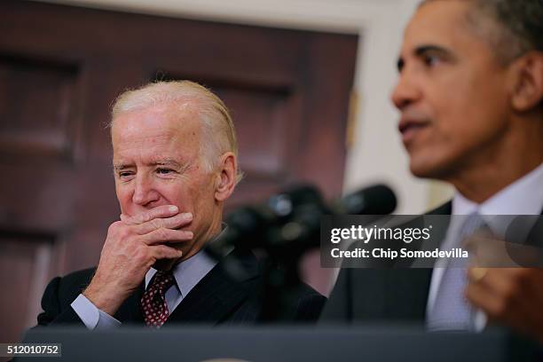 Vice President Joe Biden listens to President Barack Obama make a statement about his plan to close the detention camp at the Guantanamo Bay Naval...