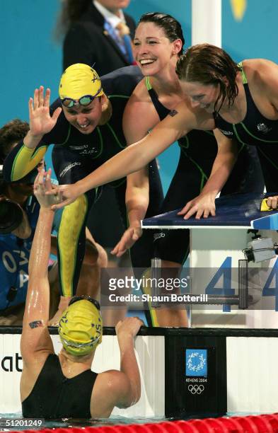 Petria Thomas, Giaan Rooney and Leisel Jones of Australia congratulate teammate freestyler Jodie Henry after they won the gold medal and set a new...