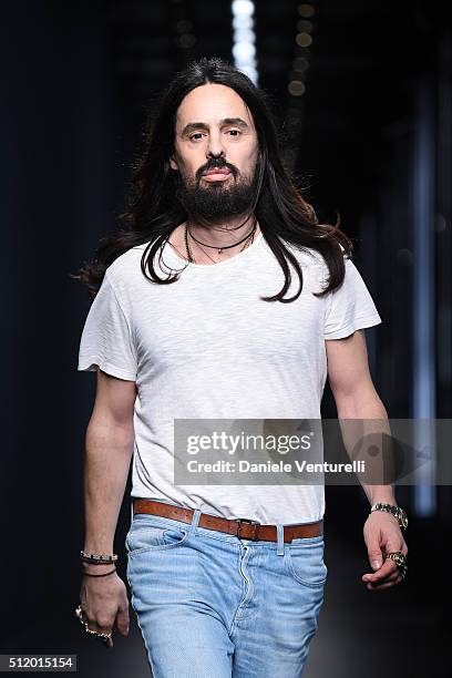 Designer Alessandro Michele acknowledges the applause of the audience after the Gucci show during Milan Fashion Week Fall/Winter 2016/17 on February...