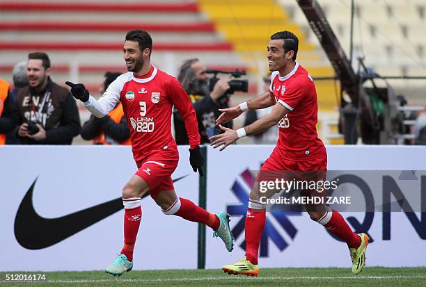 Iran's Tractorsazi player Shoja Khalilzadeh celebrates with his teammate Bakhtiar Rahmani after scoring a goal during their AFC Champions League...