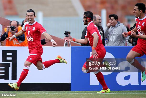 Iran's Tractorsazi player Bakhtiar Rahmani celebrates with his teammates Khaled Shafiei and Farzad Hatami after scoring a goal during their AFC...