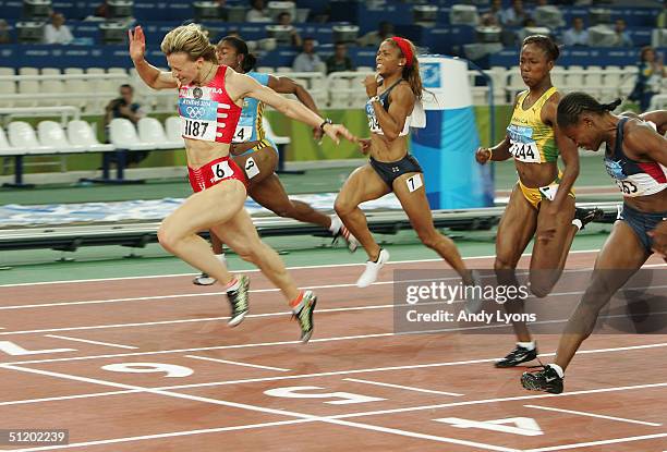 Yuliya Nesterenko of Belarus crosses the finish line as she wins gold in the women's 100 metre final on August 21, 2004 during the Athens 2004 Summer...