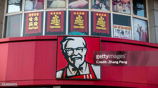Portrait of Colonel Sanders hung on the exterior of a KFC restaurant. On the early of February, KFC China triumphs in Lawsuit Over Mutant Chicken...