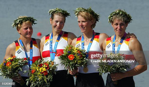 German Kathrin Boron , Meike Evers, Manuela Lutze and Kerstin El Qalqili celebrate on the podium after winning the gold medal in the women's...