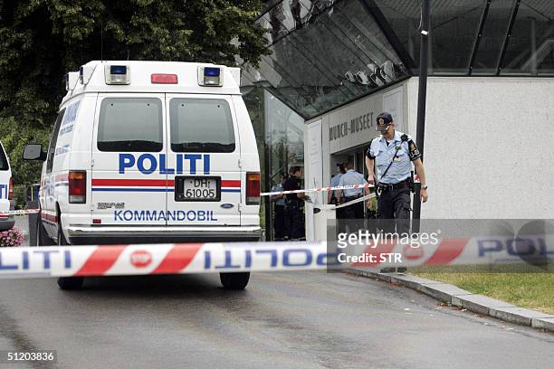 Policemen are seen in front of the Munch Museum as they investigate the robbery of several Edvard Munch paintings 22 August 2004. Edvard Munch's...