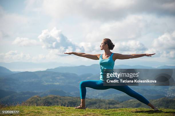 woman practicing yoga on top of a mountain - outdoor yoga stock pictures, royalty-free photos & images