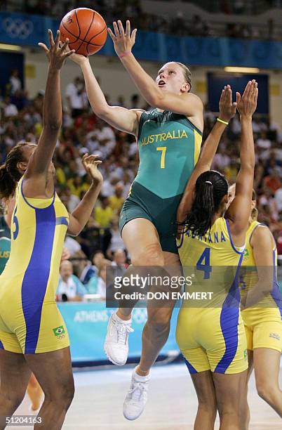 Australia's Penny Taylor grabe the basket between Brazil's Kelly Santos and Adriana Moises Pinto 22 August 2004 during the Olympic Games Women's...