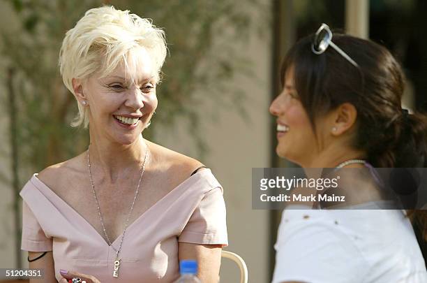 Patric Reeves and musician Noa Tisby attend the "Nina Morris Trunk Show" at Patric Reeves' home August 21, 2004 in Los Feliz, California.