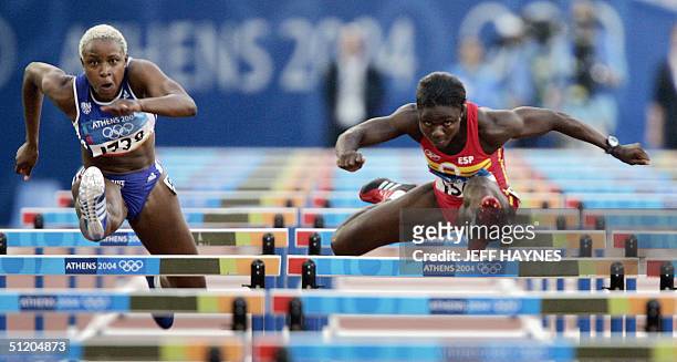 France's Linda Ferga-Khodadin and Spain's Glorie Alozie compete during the women's 100m hurdles round 1 at the Olympic Stadium 22 August 2004 during...