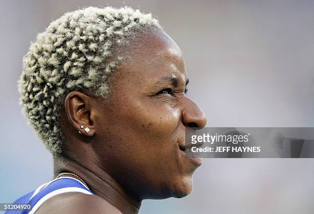 France's Linda Ferga-Khodadin reacts after competing in the women's 100m hurdles round 1 at the Olympic Stadium 22 August 2004 during the Olympic...