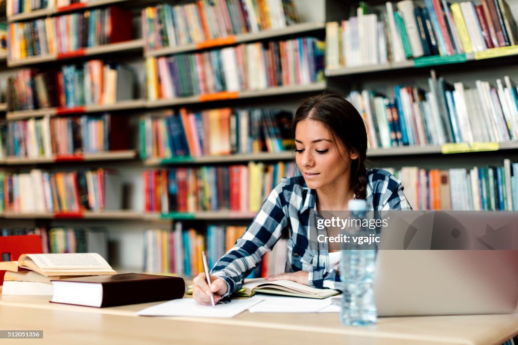 Student using laptop for taking notes to study