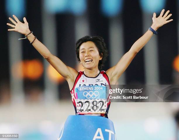 Mizuki Noguchi of Japan celebrates after finishing first and winning the gold medal in the women's marathon on August 22, 2004 during the Athens 2004...