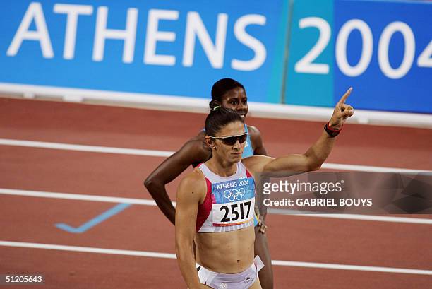 Mexico's Ana Guevara gestures after she won semi-final one of the women's 400m, 22 August 2004, during the Olympic Games athletics competitions at...