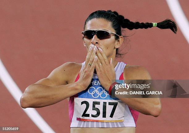 Mexico's Ana Guevara blows a kiss to the crowd after she won semi-final one of the women's 400m, 22 August 2004, during the Olympic Games athletics...