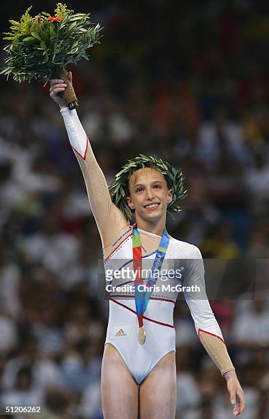 Emilie Lepennec of France receives the gold medal for the women's artistic gymnastics uneven bar event on August 22, 2004 during the Athens 2004...