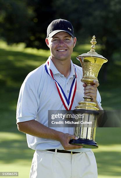 Ryan Moore of Puyallup, Washington poses with his trophy during the final round of the US Amateur Championship on August 22, 2004 at the Winged Foot...