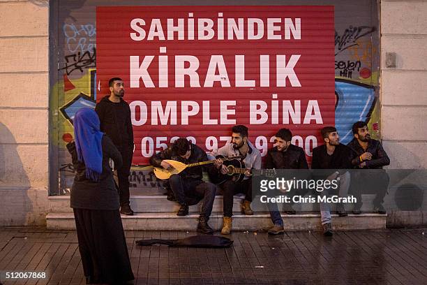 Buskers play in front of a shop available for rent on Istiklal street on February 24, 2016 in Istanbul, Turkey. Recent terrorist attacks, national...