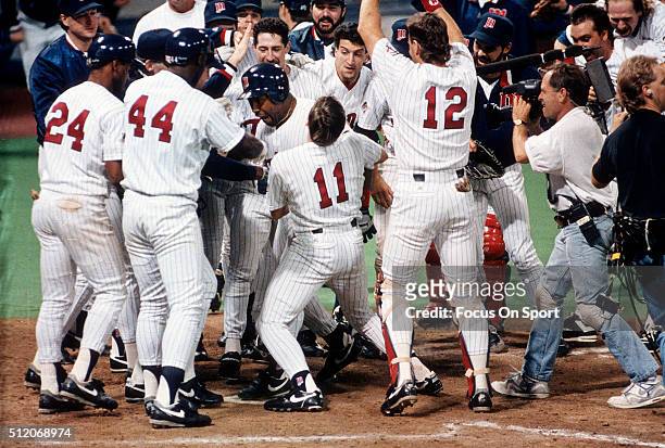 Outfielder Kirby Puckett and teammates of the Minnesota Twins celebrates after Puckett hit a walk-off home run in the bottom of the 11th inning...