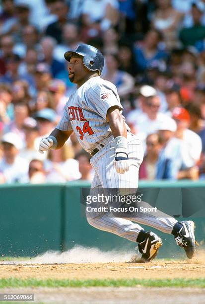 Outfielder Kirby Puckett of the Minnesota Twins bats against the Boston Red Sox during a Major League Baseball game circa 1995 at Fenway Park in...