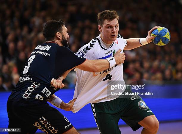 Tobias Karlsson of Flensburg challenges Christoph Steinert of Leipzig during the DKB Bundesliga handball match between SG Flensburg Handewitt and SC...