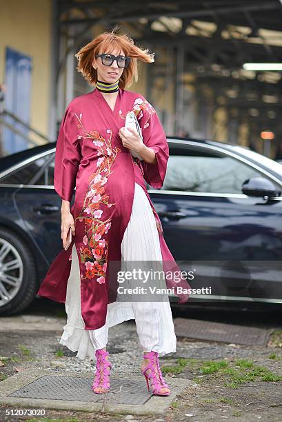 Veronica Giomini poses wearing a Whezy Shelly kimono, Messagerie skirt and Louboutin shoes before the Gucci show during the Milan Fashion Week...