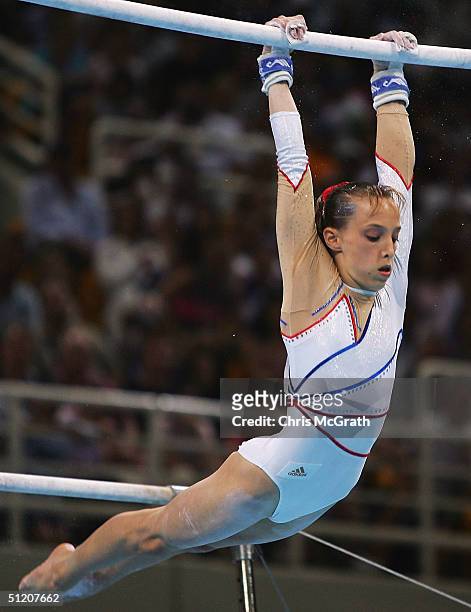 Emilie Lepennec of France in action during her gold medal performance in the women's artistic gymnastics uneven bar event on August 22, 2004 during...