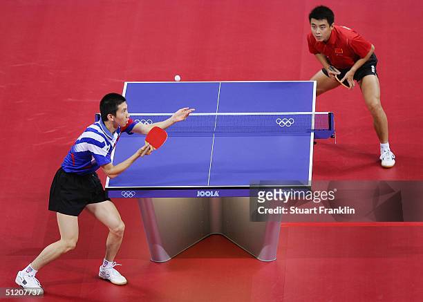 Seung Min Ryu of Korea in action with Hao Wang of China during the men's singles table tennis gold medal match on August 23, 2004 during the Athens...