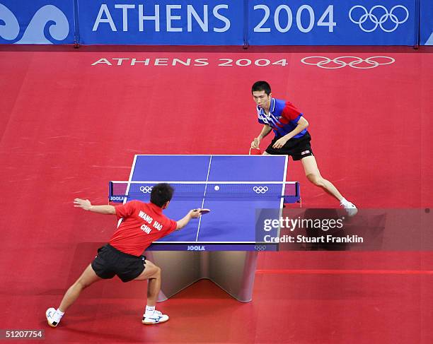 Seung Min Ryu of Korea in action with Hao Wang of China during the men's singles table tennis gold medal match on August 23, 2004 during the Athens...