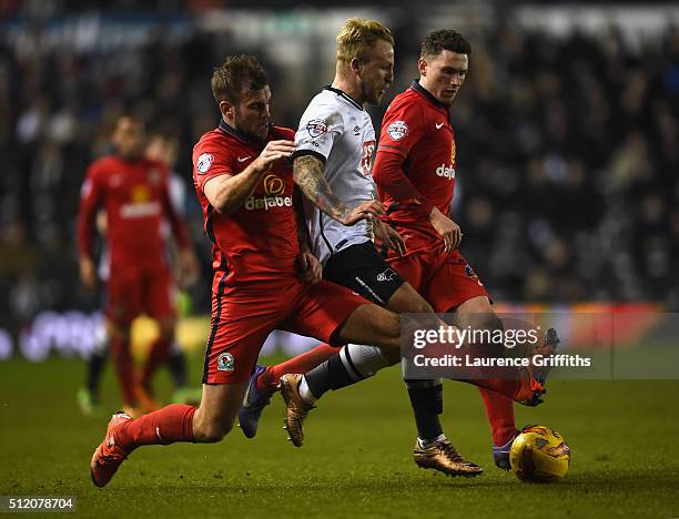 Johnny Russell of Derby County battles with Tommy Spur and Corry Evans of Blackburn Rovers during the Sky Bet Championship match between Derby County...