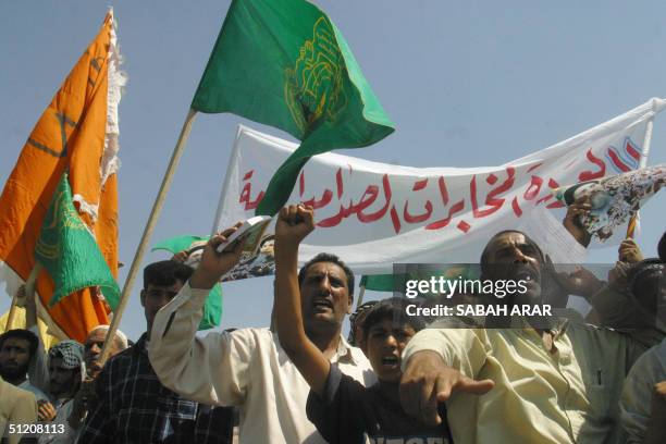 Supporters of the Iraqi Hezbollah party demonstrate in front of the so-called Green Zone, which houses government offices and the US embassy, in...