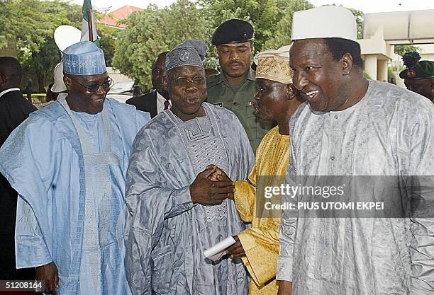 Secretary General of the Africa Union Alpha Omar Konare and Nigerian Vice President Abubakar Atiku smiles as President Olusegun Obasanjo holds his...