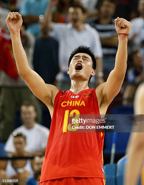China's Yao Ming lest out a scream after his team's victory over Serbia and Montenegro 23 August 2004 during the Olympic Games Men's Basketball...