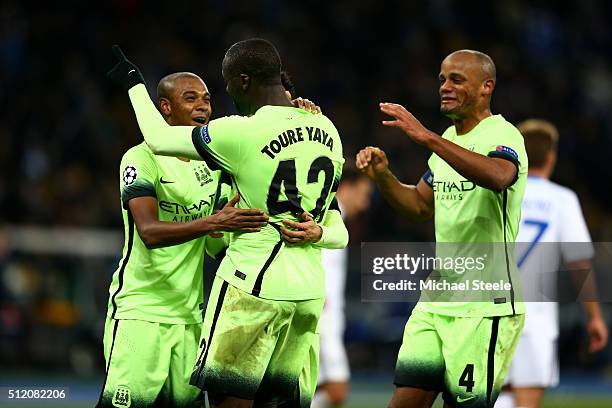 Fernandinho, Yaya Toure and Vincent Kompany of Manchester City celebrate their team's 3-1 victory as the final whistle blows during the UEFA...