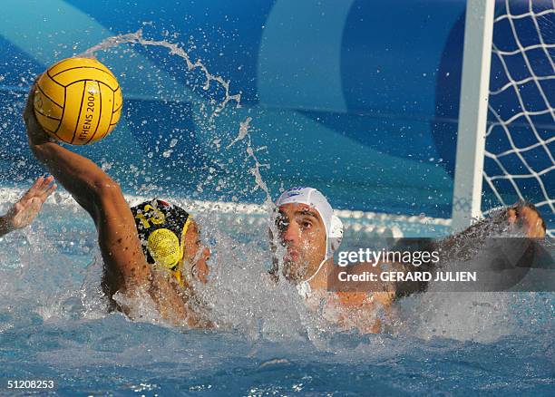 Egyptian Walid Rezk vies with Gabriel Hernandez during their men's preliminaries-Groupe B waterpolo match, at the Olympic aquatic center at the 2004...