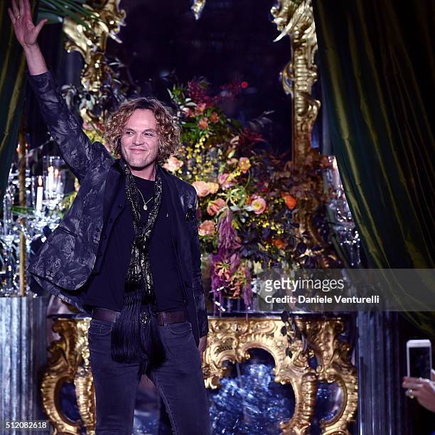 Designer Peter Dundas acknowledges the applause of the public after the Roberto Cavalli show during Milan Fashion Week Fall/Winter 2016/17 on...