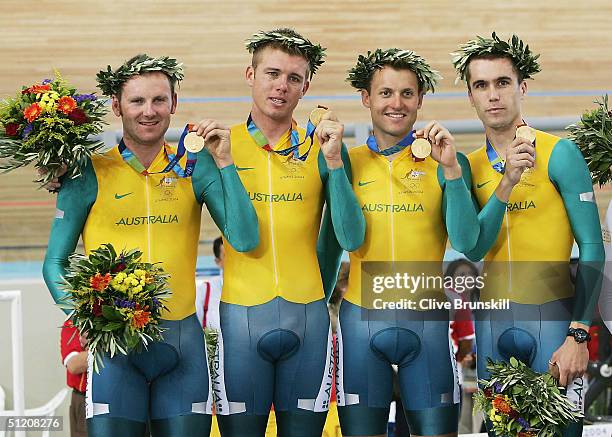 Graeme Brown, Brett Lancaster, Luke Roberts and Brad McGee of team Australia celebrate with their gold medals after winning the men's track cycling...