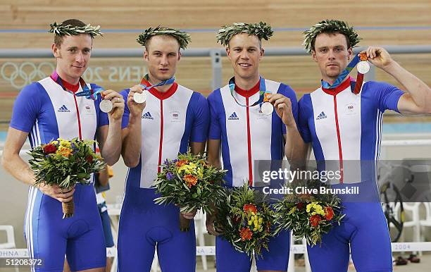 Bradley Wiggins, Steve Cummings, Paul Manning and Chris Newton of team Great Britain celebrate after receiving their silver medals in the men's track...