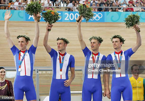 Steve Cummings, Paul Manning, Chris Newton, Bradley Wiggins of team Great Britain celebrate after receiving their silver medalsl in the men's track...